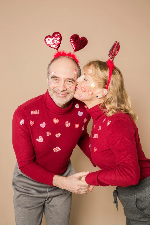 a man and a woman posing for a picture, falling hearts, wearing festive clothing, profile image, john baer