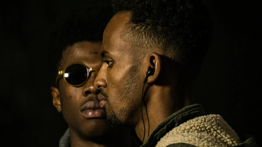 a couple of men standing next to each other, by Charles Martin, trending on pexels, afrofuturism, making out, gauged ears, promo still, romantic lead