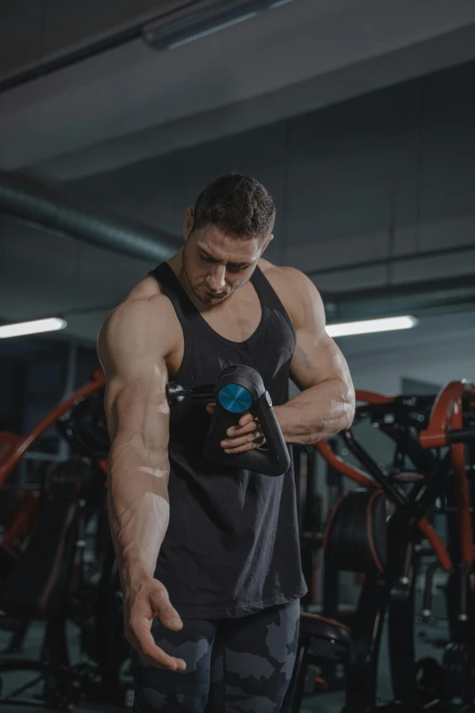 a man standing next to a machine in a gym, by Adam Marczyński, pexels contest winner, renaissance, big biceps, pouring, 3 dimensional, square