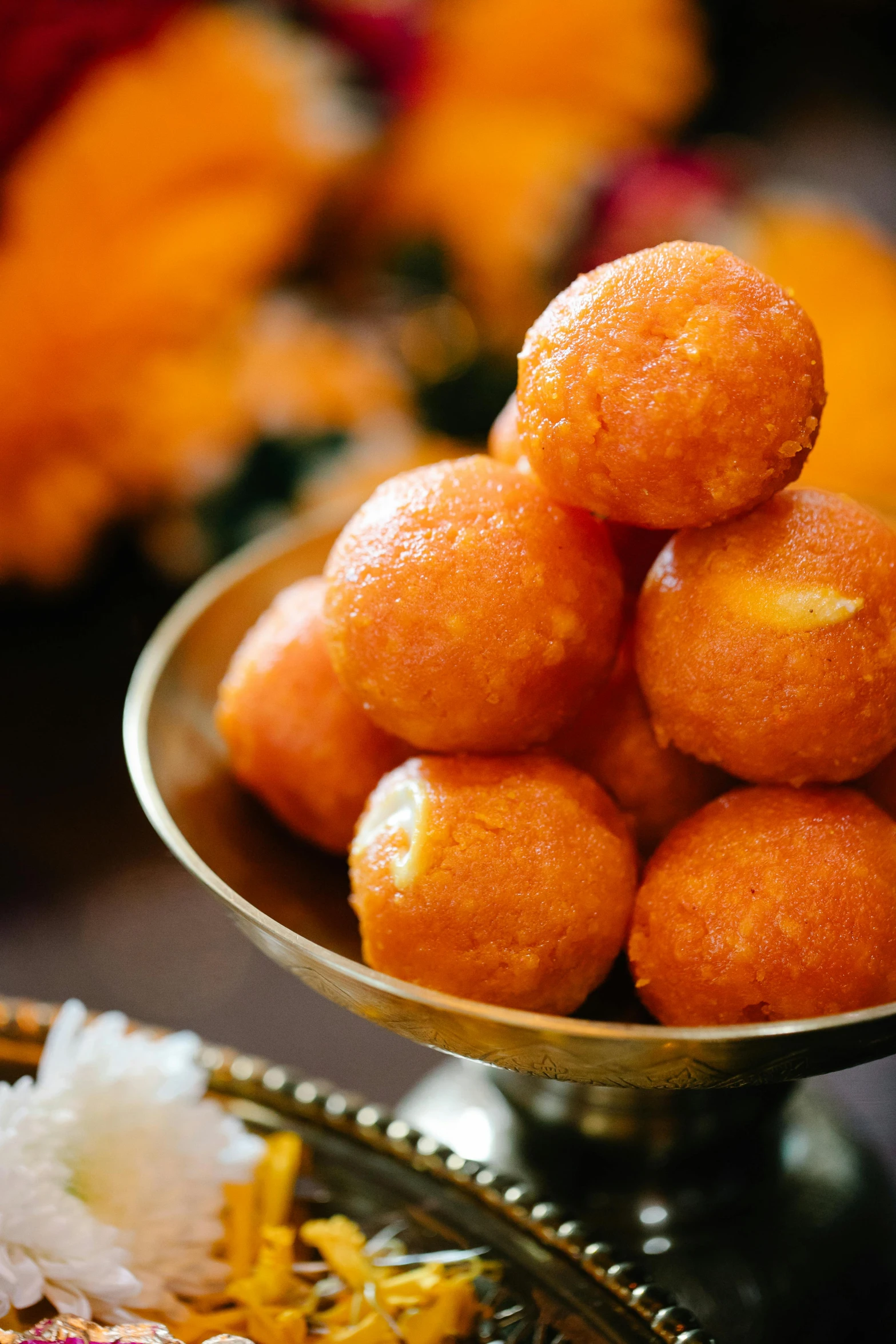 a close up of a plate of food on a table, golden orbs, kali, puffy, orange