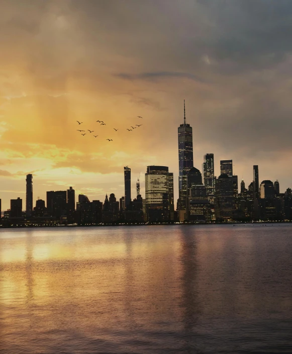 a large body of water with a city in the background, pexels contest winner, hudson river school, snapchat photo, humid evening, album cover, cinematic post - processing