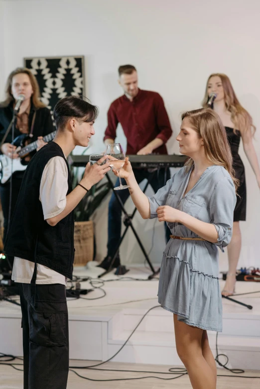 a group of people that are standing in a room, an album cover, trending on pexels, couple dancing, band, ukrainian, college party