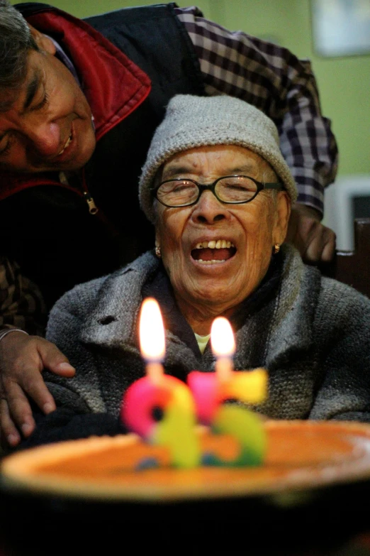 a woman blowing out candles on a birthday cake, flickr, ap news photograph, old man, yan gisuka, multiple stories