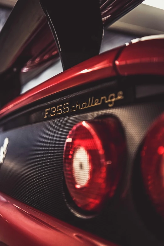 a close up of the tail lights of a red sports car, pexels contest winner, hyperrealism, 2 5 6 x 2 5 6, chest plate with ferrari logo, f50, banner