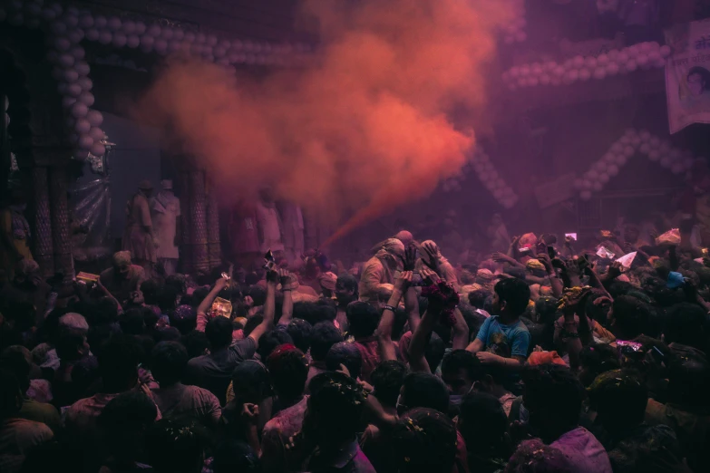 a crowd of people standing on top of a stage, unsplash contest winner, process art, pink smoke, indian temple, in a nightclub, dust motes in air