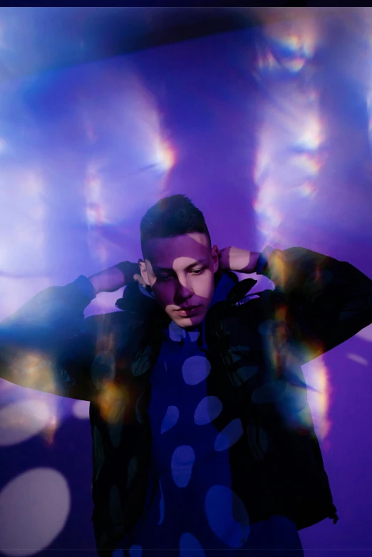 a man that is standing in front of some lights, an album cover, by Julia Pishtar, pexels, holography, purple scene lighting, bad bunny, transparent celestial light gels, an artistic pose