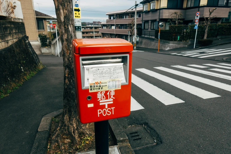 a red post box sitting on the side of a road, by Yasushi Sugiyama, unsplash, mapbox, japanese collection product, 🚿🗝📝