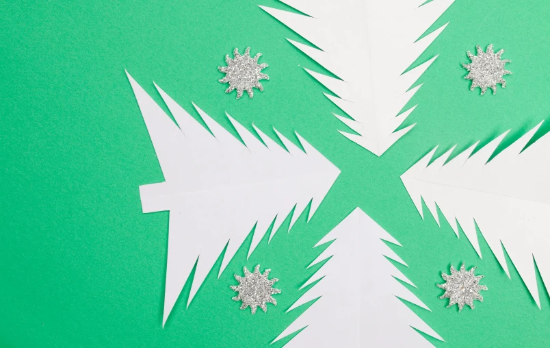 a close up of paper snowflakes on a green surface, by Julia Pishtar, spruce trees on the sides, white background : 3, background image, ffffound