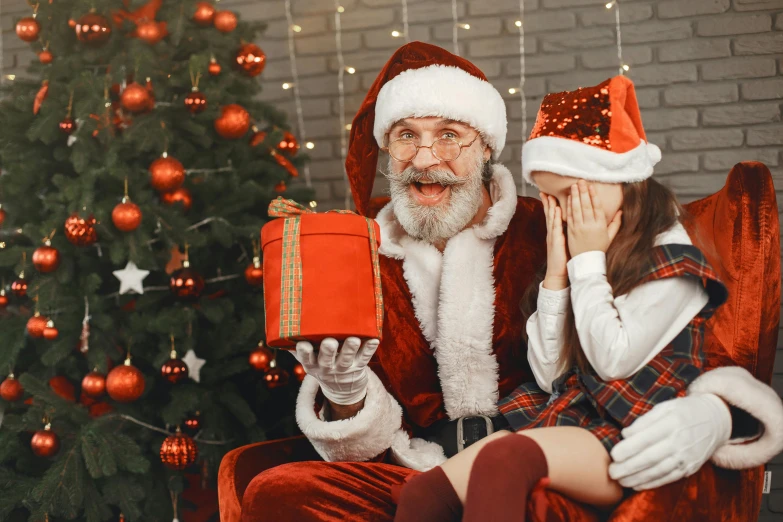 a couple of people sitting next to a christmas tree, pexels contest winner, hide the pain harold, 🎀 🗡 🍓 🧚, kramskoi 4 k, with a kid