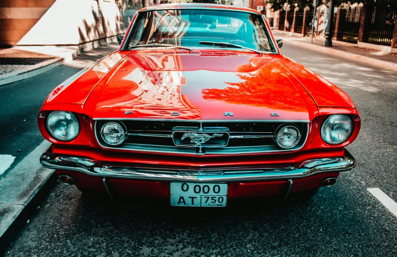 a red car parked on the side of the road, pexels contest winner, photorealism, mustang, 🦩🪐🐞👩🏻🦳, in retro colors, sparkling in the sunlight