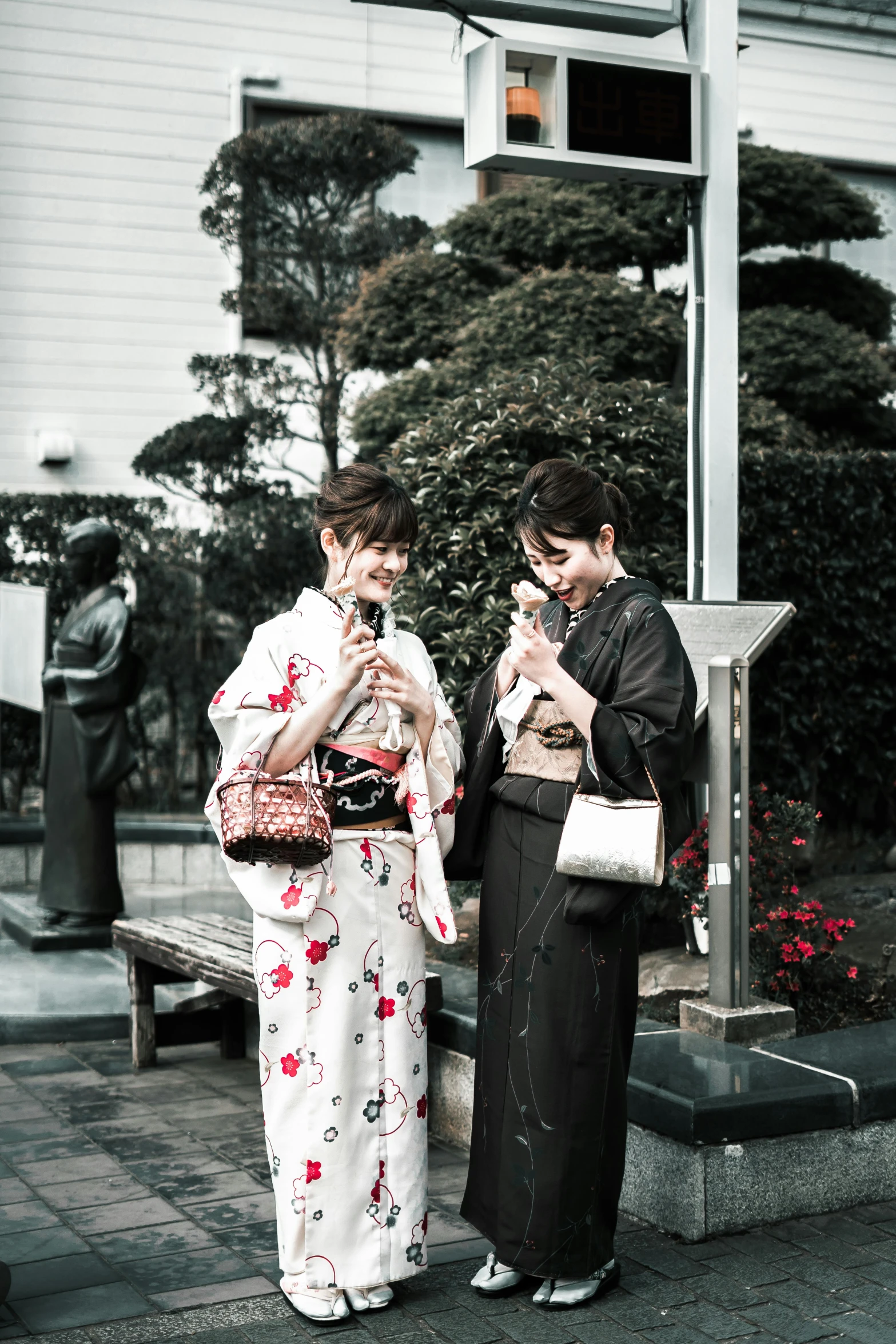 a couple of women standing next to each other on a sidewalk, a colorized photo, unsplash, ukiyo-e, classy yukata clothing, drinking, instagram story, enjoying life!!! elegant