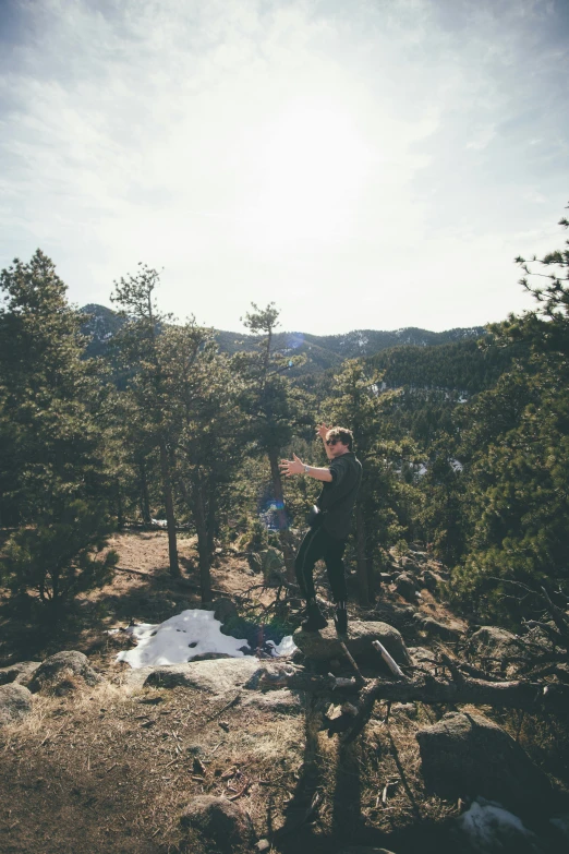 a man riding a bike on top of a mountain, by Jacob Burck, unsplash, process art, hanging from a tree, hiking in rocky mountain, dabbing, disposable camera photo