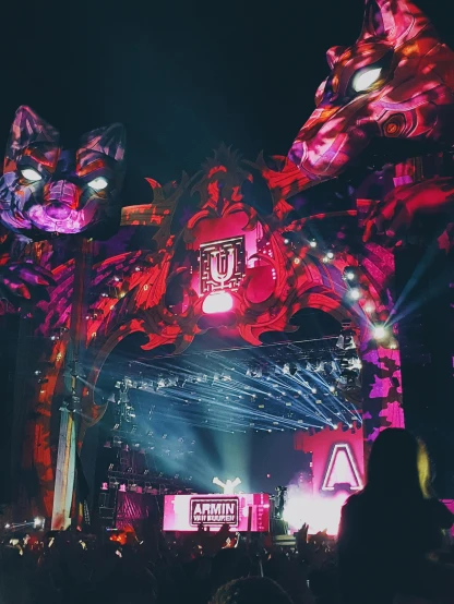 a group of people standing on top of a stage, girl with cat ears at a rave, giant majestic archways, a tiger, letter a