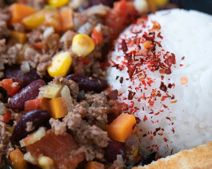 a close up of a plate of food with rice, by Carey Morris, trending on unsplash, chili, leftover meat pie, hasbulla, thumbnail