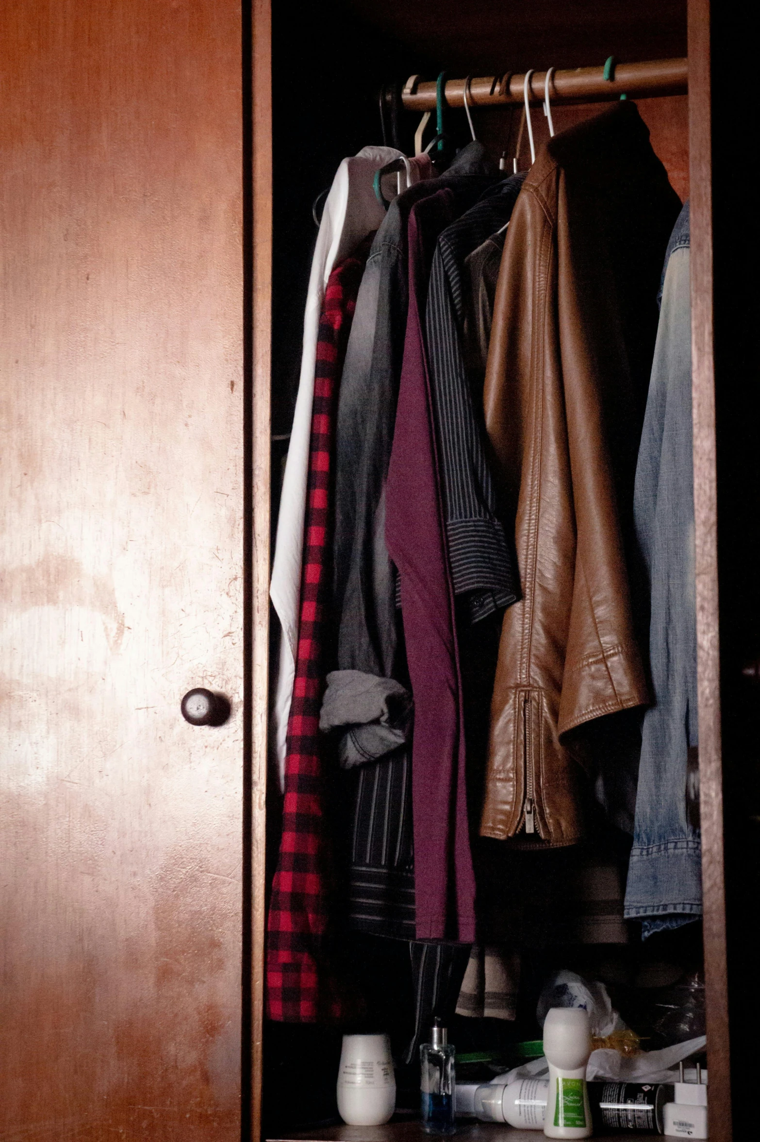 a closet filled with lots of clothes and shoes, a portrait, pexels, wearing a brown leather coat, digital image, blank, worn