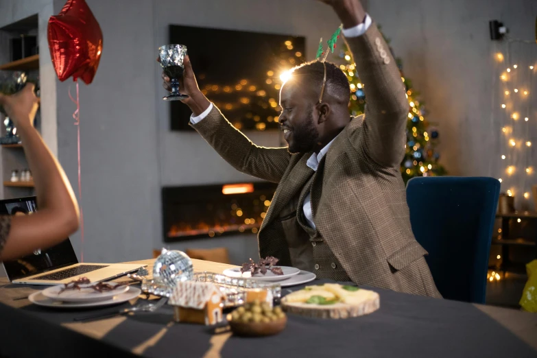 a man sitting at a table with a glass of wine, pexels contest winner, wearing festive clothing, shaq, celebrating, avatar image