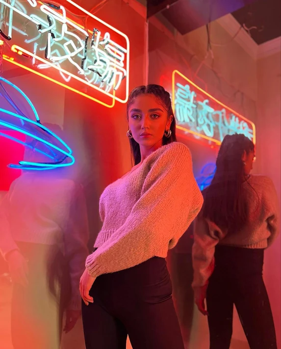 a woman standing in front of a neon sign, by Robbie Trevino, trending on pexels, holography, :: madison beer, standing in front of a mirror, imaan hammam, asian women