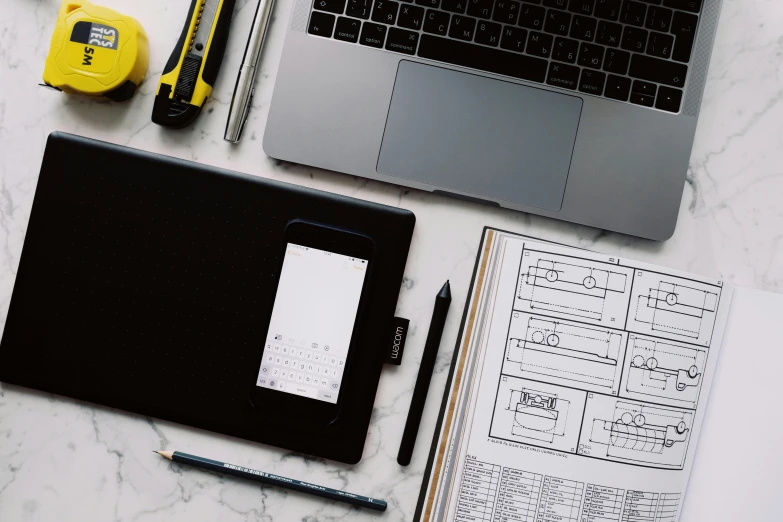 an open laptop computer sitting on top of a desk, a drawing, pexels contest winner, architectural plans, knolling, worksafe. instagram photo, teaching