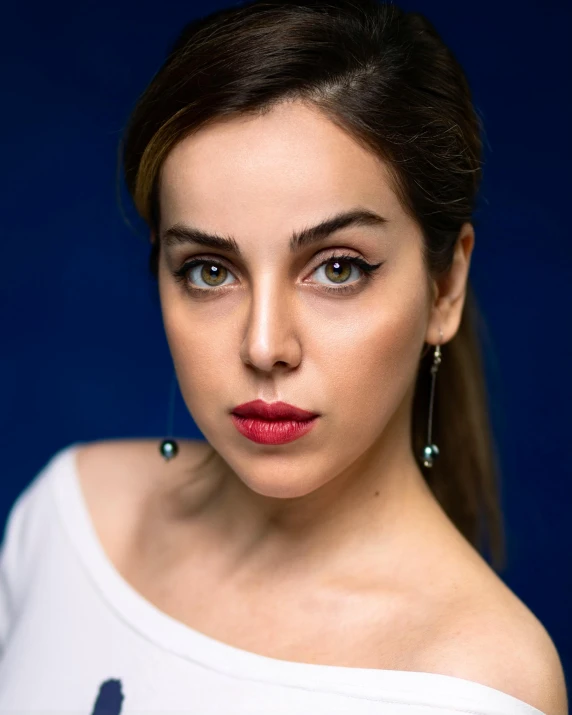 a woman in a white shirt posing for a picture, inspired by Elsa Bleda, pexels contest winner, photorealism, charli xcx, blue symmetric eyes 24yo, beautiful iranian woman, acting headshot