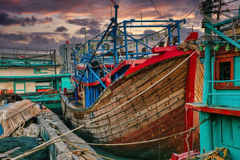 a large wooden boat sitting on top of a body of water, inspired by Steve McCurry, pexels contest winner, auto-destructive art, fishing town, brilliantly coloured, under repairs, youtube thumbnail