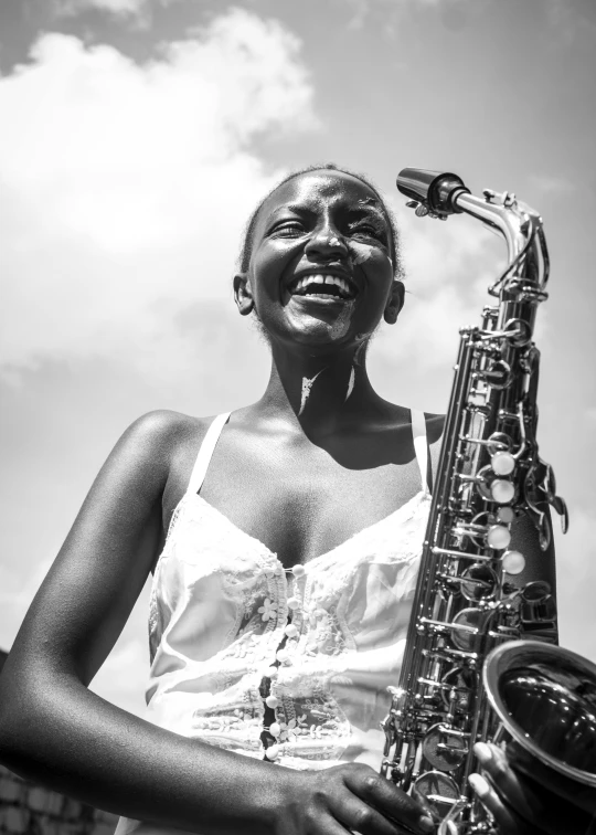 a black and white photo of a woman playing a saxophone, by Joze Ciuha, smiling in heaven, on a bright day, african, 15081959 21121991 01012000 4k