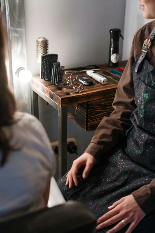 a woman sitting in a chair in front of a mirror, tattoo artist, on a wooden tray, oil slick, profile image