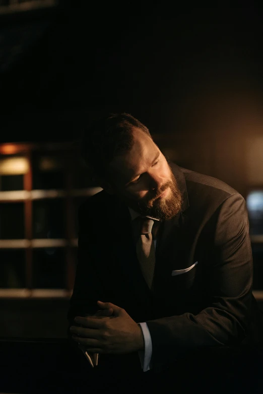 a man with a beard wearing a suit and tie, an album cover, inspired by Ásgrímur Jónsson, unsplash, moody night lighting, resting, scott wozniak, photo from a promo shoot