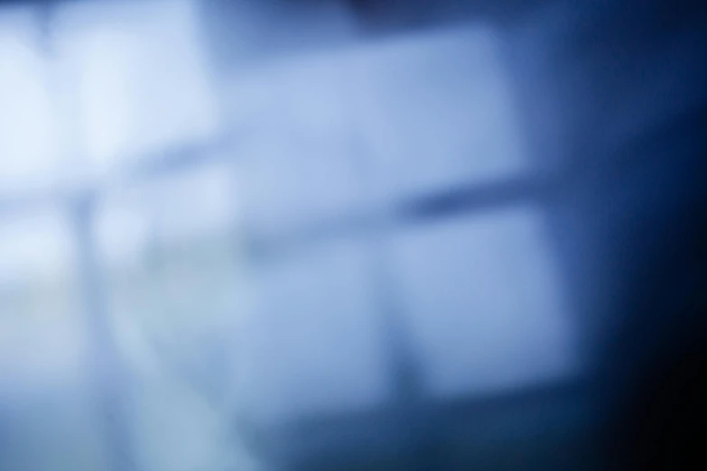 a close up of a toothbrush with a blurry background, an album cover, inspired by Anna Füssli, abstract illusionism, cold blue light from the window, squares, office background, light reflecting off windows