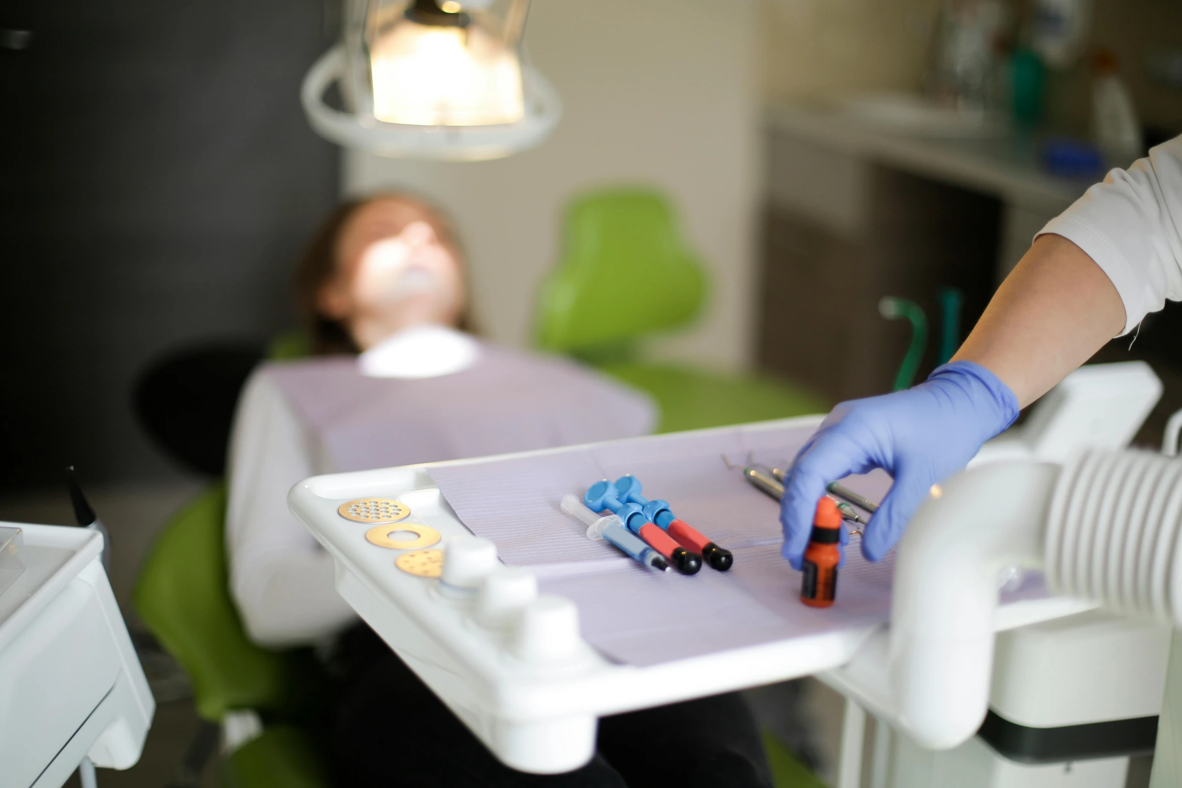 a person that is sitting in a chair with a tray, an airbrush painting, by Adam Marczyński, pexels contest winner, hurufiyya, dentist, plating, sterile colours, small jaw