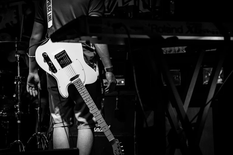 a black and white photo of a man playing a guitar, by Dave Melvin, pexels contest winner, happening, heavy rock concert, futuristic electric guitar, detailed white, rectangle