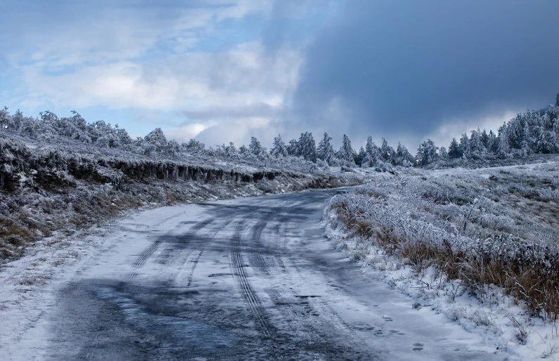 a snow covered road with trees in the background, by Hallsteinn Sigurðsson, pexels contest winner, blue ice, wales, thumbnail, panorama