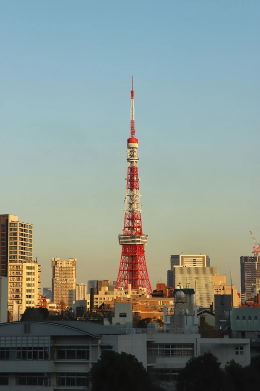 a tall red tower towering over a city, by Miyamoto, antenna, no cropping, ap news, fan favorite