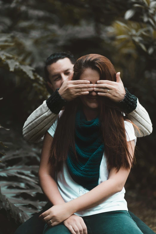 a woman covering her eyes while sitting next to a man, a picture, inspired by Elsa Bleda, spirit hugs, lush surroundings, woman holding another woman, profile pic