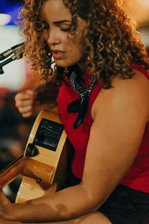 a woman playing a guitar and singing into a microphone, profile image, curly haired, kete butcher, student