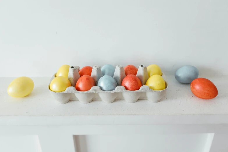 a tray of eggs sitting on top of a table, inspired by Luma Rouge, multi colour, cast, medium, pot