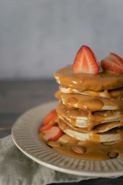 a stack of pancakes covered in peanut butter and strawberries, inspired by Richmond Barthé, unsplash, portrait photo, caramel, 6 pack, kek