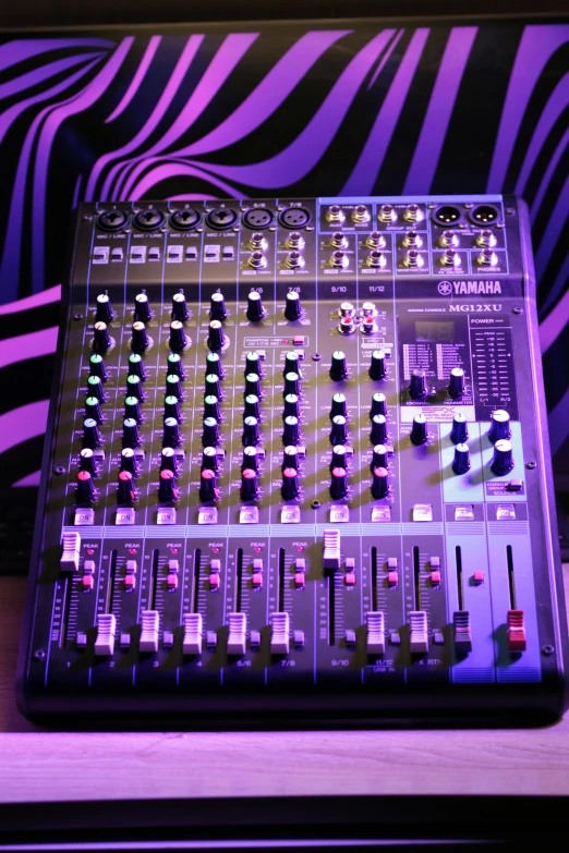 a mixer sitting on top of a wooden table, flickr, pop art, purple lights, sennheiser, club, control panel