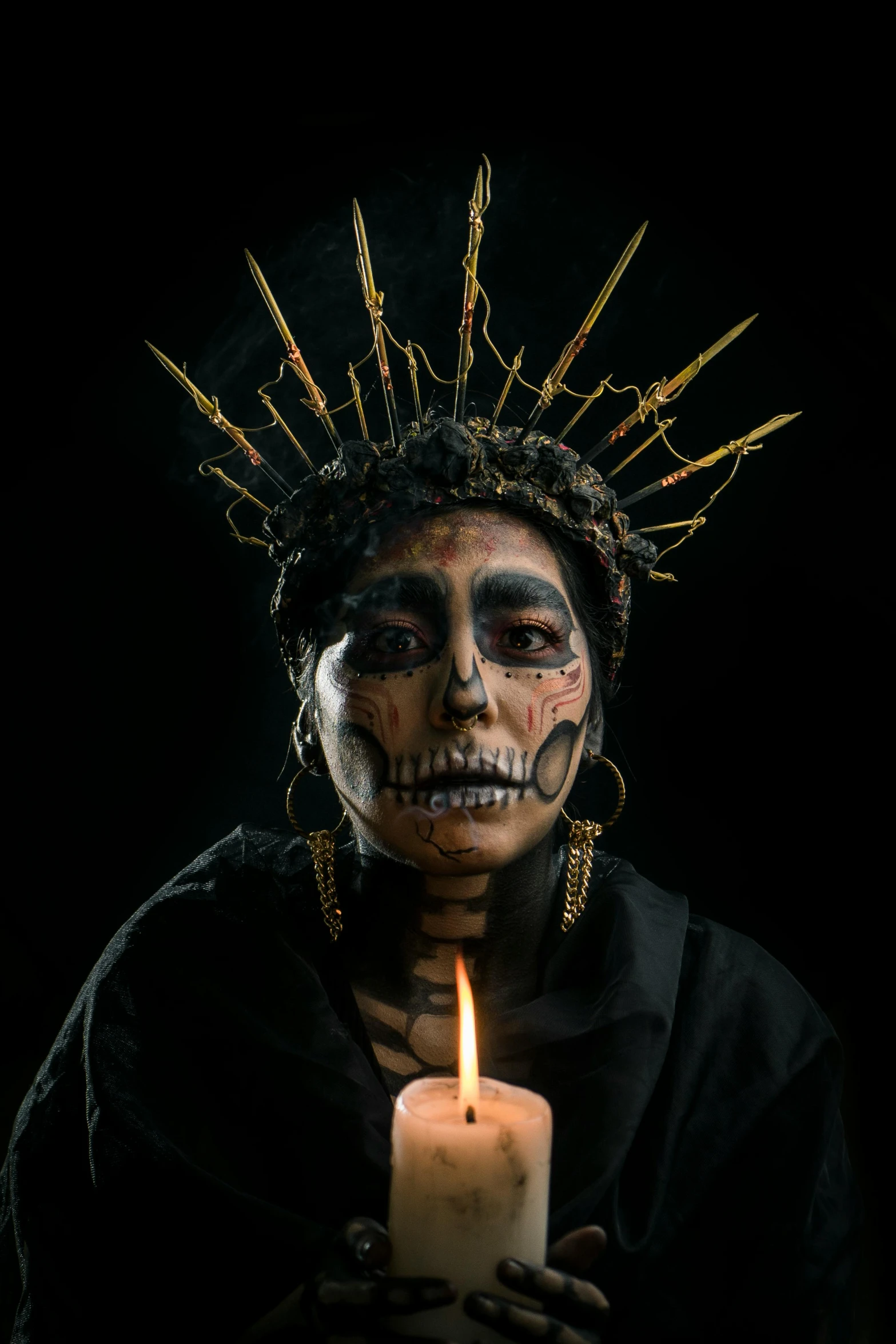 a woman dressed as a skeleton holding a candle, an album cover, by Alejandro Obregón, pexels contest winner, facial tribal markings, crown on head, holy, shamanism