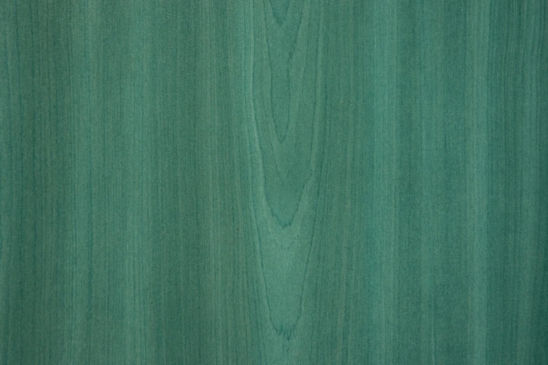 a close up of a green wood surface