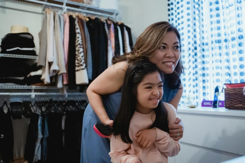 a woman standing next to a little girl in a room, inspired by Ruth Jên, pexels contest winner, happening, earing a shirt laughing, tyler edlin and natasha tan, elegantly dressed, profile image