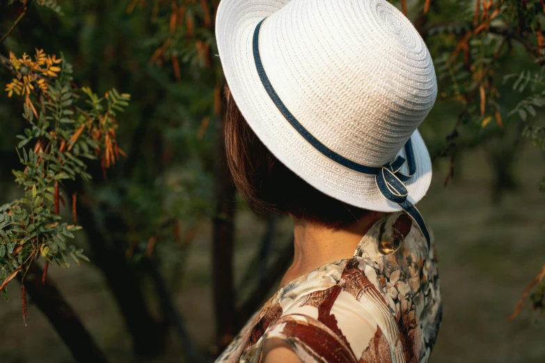 a close up of a person wearing a hat, al fresco, ribbon, white, graphic print