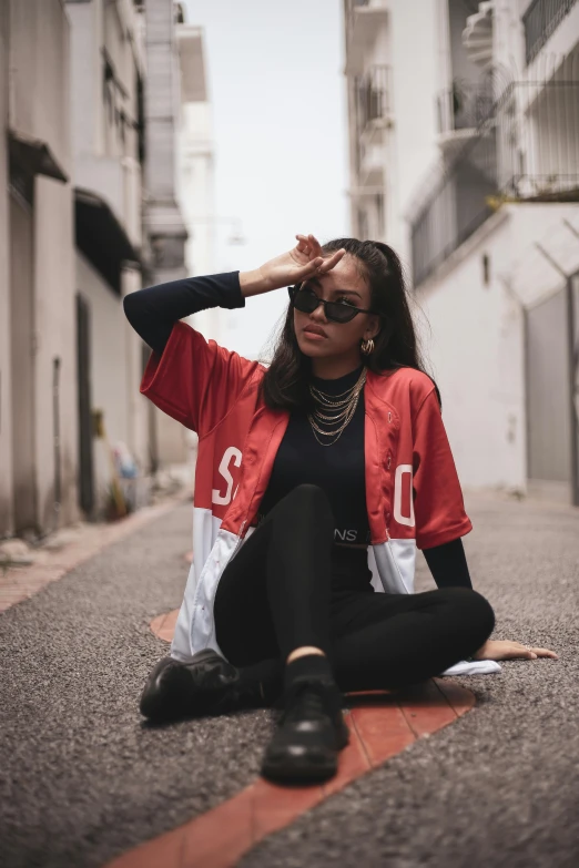 a woman sitting on the side of a road, trending on pexels, graffiti, black and red jacket, with sunglass, symmetrical image, asian women