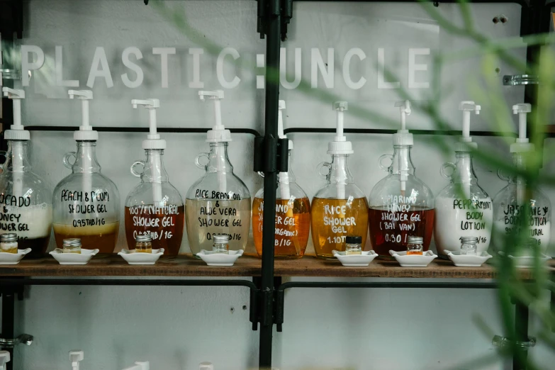 a bunch of bottles that are on a shelf, trending on unsplash, plasticien, lettering clean, uncle aloysius, brown and white color scheme, shop front