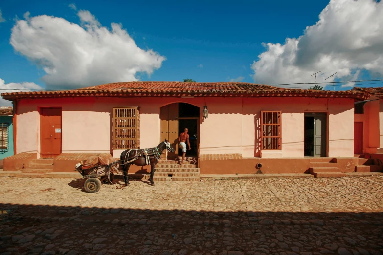 a horse pulling a cart down a cobblestone street, visual art, cuban setting, village house, profile image, dezeen