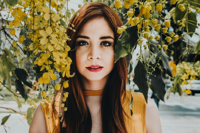 a woman standing in front of a tree with yellow flowers, a portrait, by Julia Pishtar, pexels contest winner, young beautiful amouranth, cinnamon skin color, karen gillan, vine and plants and flowers