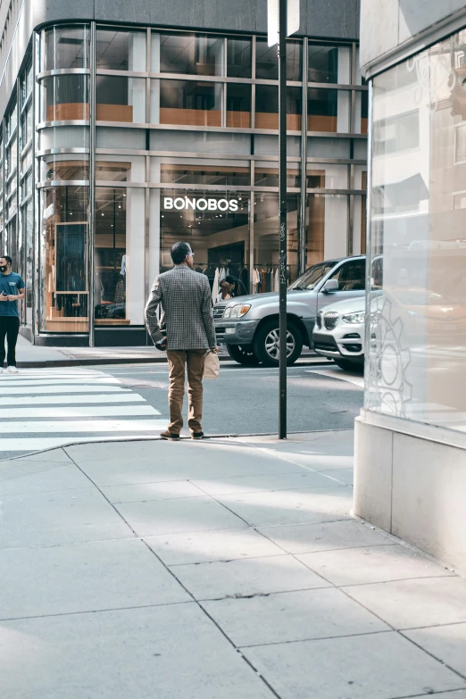 a man riding a skateboard down a city street, by Dennis Flanders, trending on unsplash, on madison avenue, exiting store, accurate boroque, a person standing in front of a