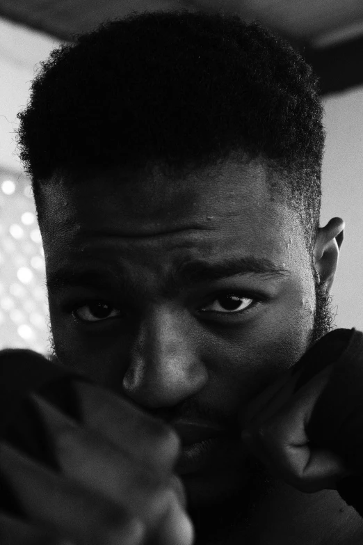 a black and white photo of a young man, inspired by Paul Georges, reddit, frank ocean, angry looking at camera, jaylen brown, character close up