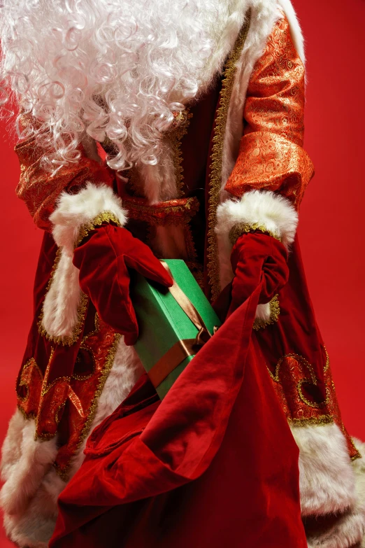 a close up of a santa claus figurine on a red background, an album cover, by Brian Thomas, pexels, photorealism, wearing long royal robe, giving gifts to people, gif, ap