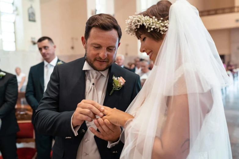 a man putting a wedding ring on a woman's finger, a photo, by Adam Marczyński, renaissance, matteo salvini, in church, thumbnail, digital image