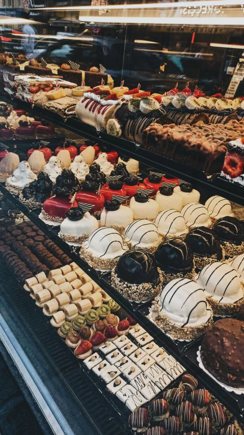 a display case filled with lots of desserts, by Robbie Trevino, pexels, hyperrealism, made of glazed, in rows, market, instagram post